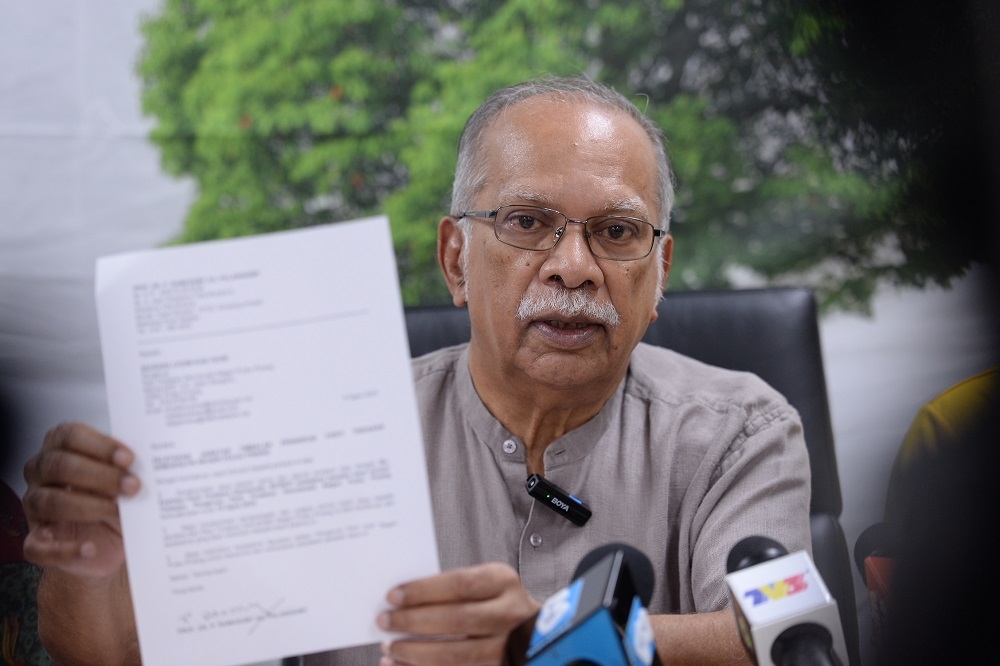 Prof P. Ramasamy holding up his resignation letter during a press conference at his former service centre in Jalan Chain Ferry, Seberang Perai August 10, 2023. ― Picture by KE Ooi