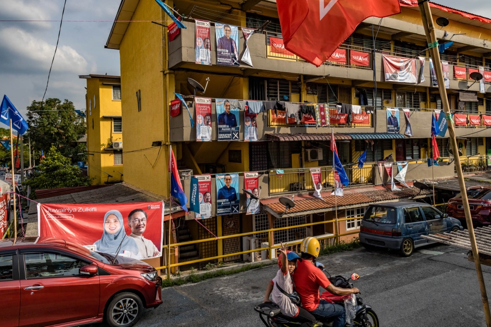 Flats in Melawati show divided support for PH and PN as seen by the election posters. — Picture by Firdaus Latif   