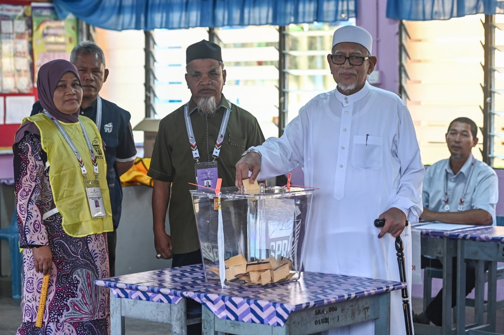 PAS president Tan Sri Abdul Hadi Awang casts his ballot at at Sekolah Kebangsan Rusila in Marang August 12, 2023. ― Bernama pic