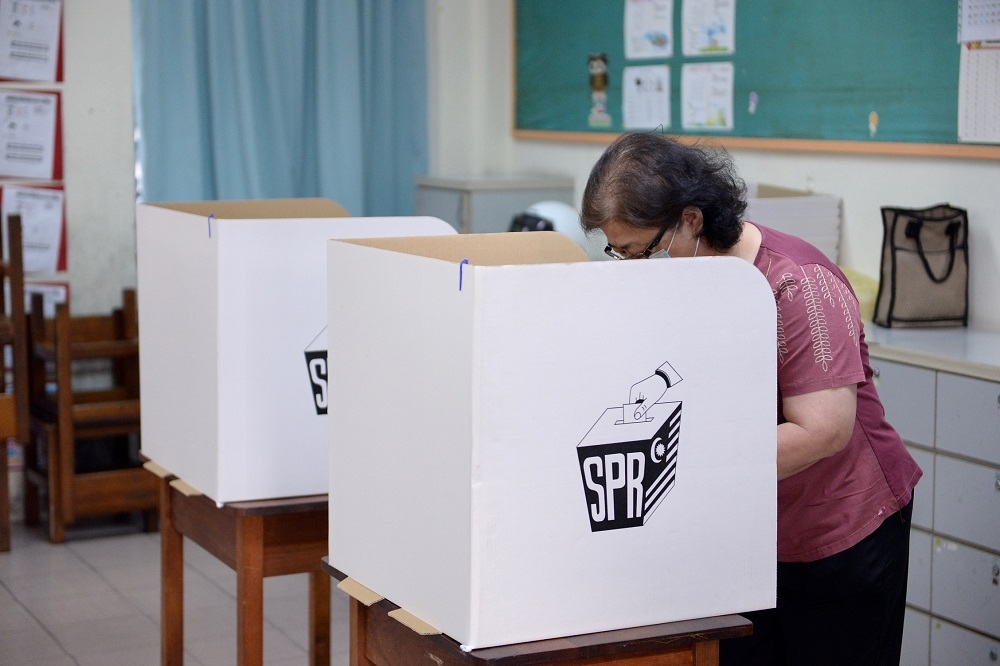 A voter casts her ballot at a polling station in George Town August 12, 2023. ― Picture by KE Ooi