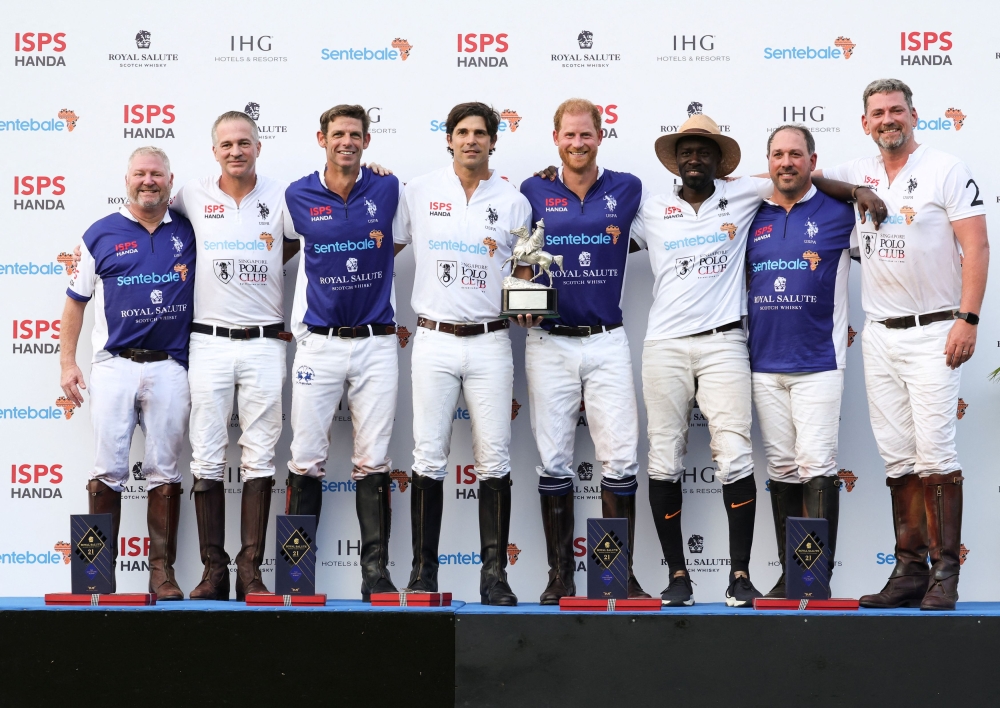 Britain’s Prince Harry, the Duke of Sussex, poses for photos with his team Royal Salute Sentebale and team Singapore Polo Club after the Sentebale ISPS Handa Polo Cup at the Singapore Polo Club in Singapore August 12, 2023. — Reuters pic