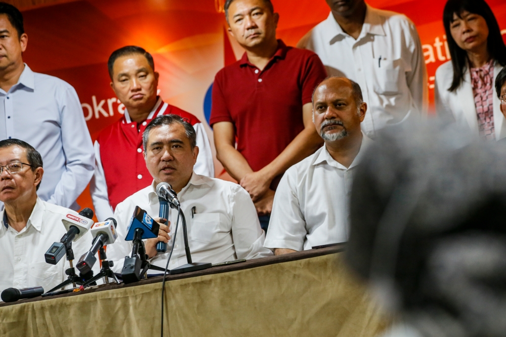 DAP secretary-general Anthony Loke (centre) speaks to the media during a press conference at DAP headquarters in Kuala Lumpur, August 14, 2023. — Picture by Hari Anggara