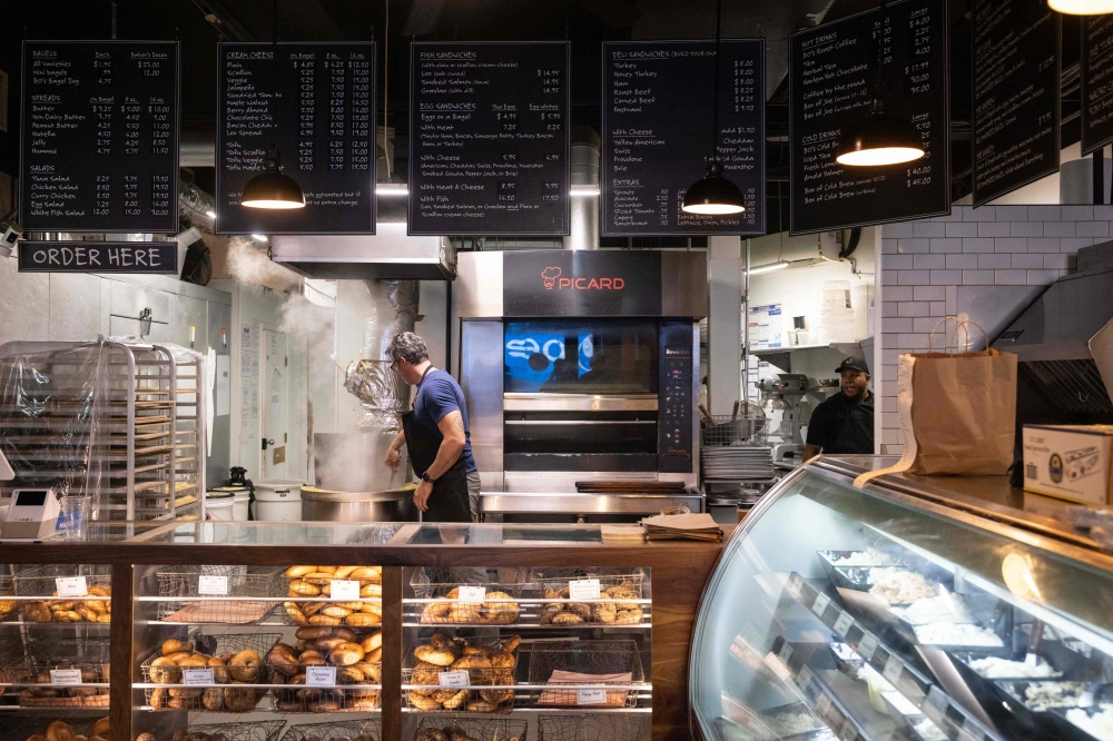 Andrew Martinez boils bagel dough balls in his store on July 12, 2023 in New York City. — AFP pic