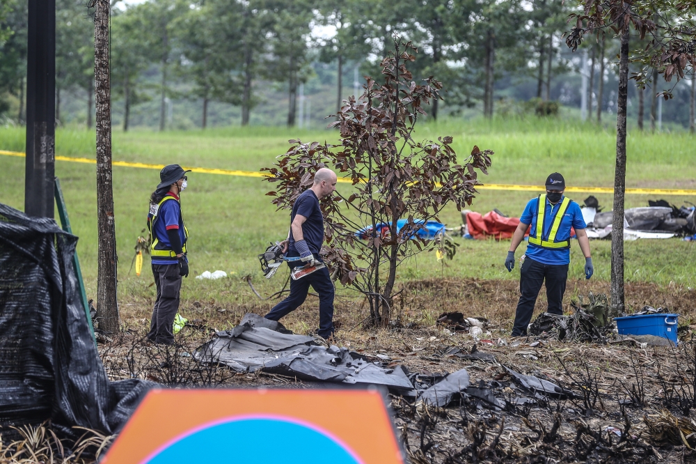 Investigators from the United States National Transportation Safety Board (NSTB), Federal Aviation Administration (FAA) and the Beechcraft aircraft manufacturer at the site of Elmina plane crash in Shah Alam, on August 21, 2023. — Picture by Yusof Mat Isa