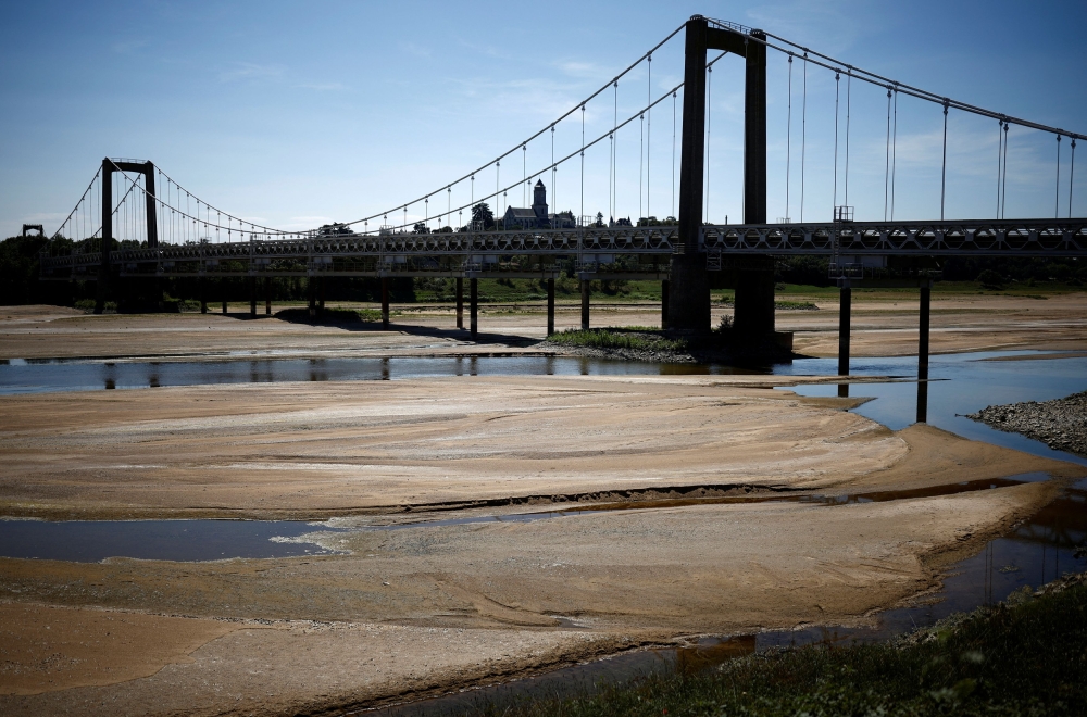 A view shows a bridge with sandbanks on a branch of the Loire River in Loireauxence, France, August 21, 2023. — Reuters pic