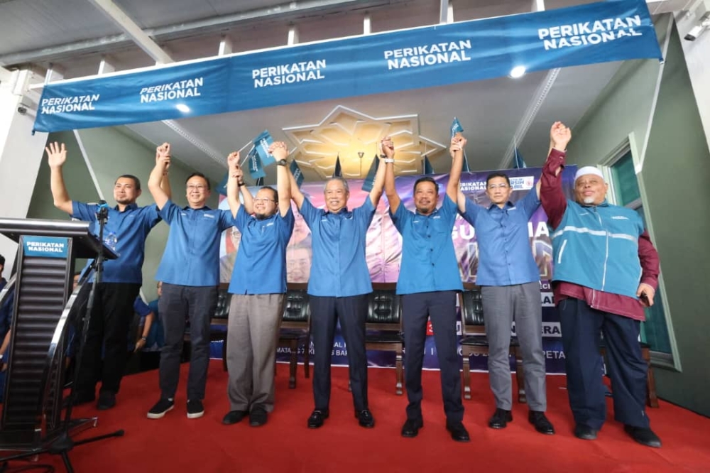 Perikatan Nasional chairman Tan Sri Muhyiddin Yassin (centre) with the Pulai parliamentary and Simpang Jeram state by-election candidates during an announcement ceremony in Kempas Baru, Johor Baru August 23, 2023. — Picture by Ben Tan