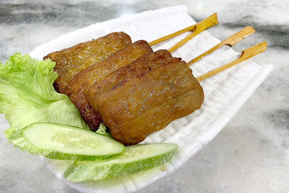 Typical Thai street food: 'moo ping' or grilled pork skewers.