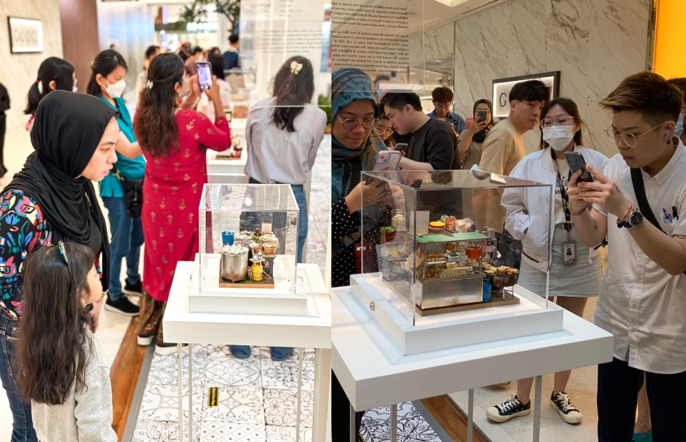 Shoppers marvelling at Siow’s putu piring (left) and mamak dioramas. — Picture courtesy of The Gardens Mall