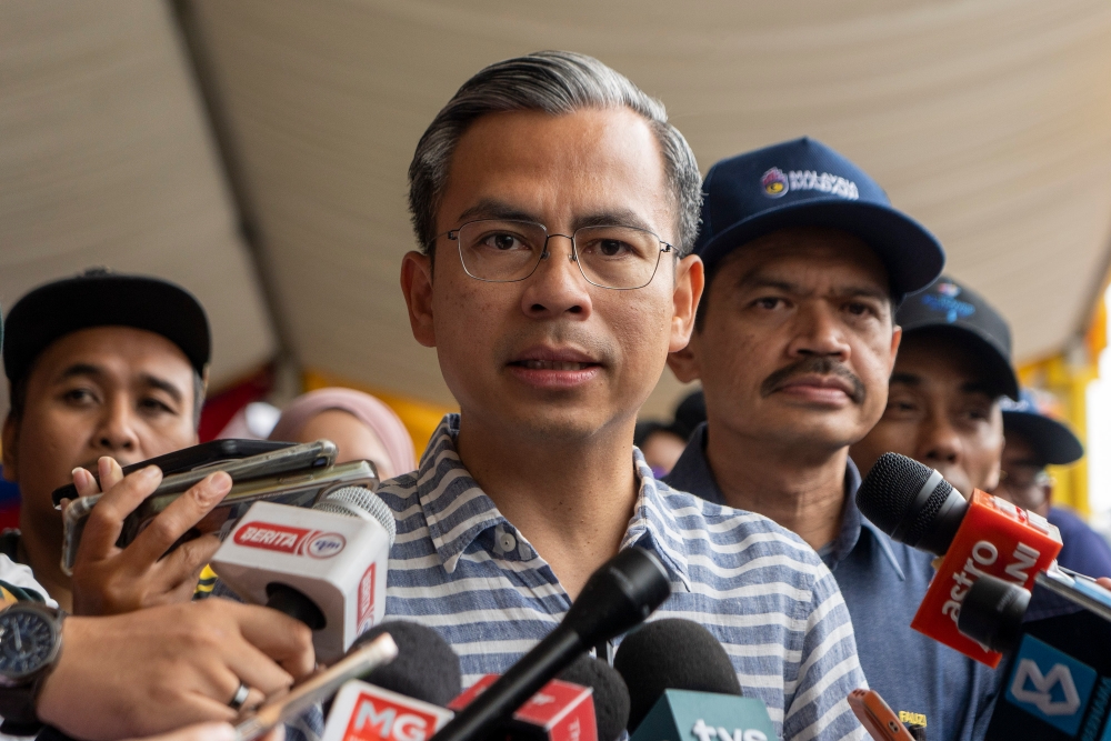 Communications and Digital Minister Fahmi Fadzil speaks to reporters after checking on preparations in conjunction with the 2023 National Day celebration at Dataran Putrajaya 26 August 2023. — Picture by Shafwan Zaidon