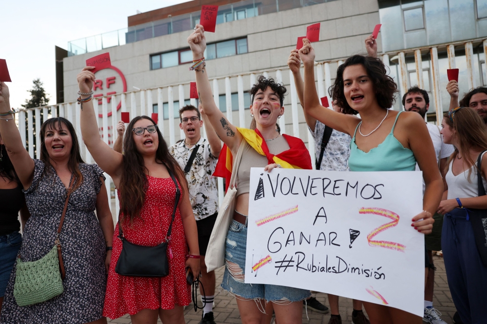 File photo of people holding banners as they protest against President of the Royal Spanish Football Federation Luis Rubiales in Las Rozas, Spain, August 25, 2023. ― Reuters pic