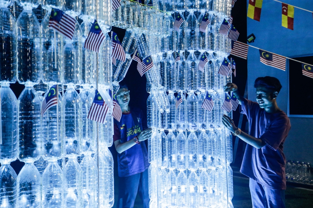 Known as ‘Afiqxcasting’ on the immensely popular short form video posting service, his six-foot tall KLCC sculpture — expected to be finished today — is made entirely out of recycled bottles. — Picture by Sayuti Zainudin