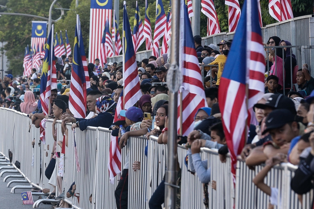 People came as early as 6am to secure a place in the multi-level rows of seats provided or to stand right in front of the procession to get a clear view of the show. — Picture by Sayuti Zainudin 