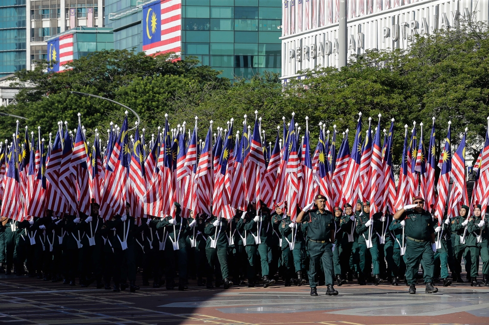 Uniformed personnel march past during the full dress rehearsal. — Picture by Sayuti Zainudin 