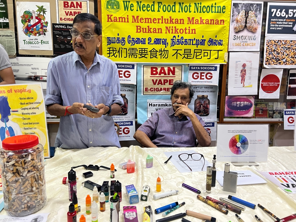 CAP’s Mohideen Abdul Kader (right) and Subbarow showing the vape devices easily available online and in shops at the CAP office in George Town August 30, 2023. — Picture by Opalyn Mok