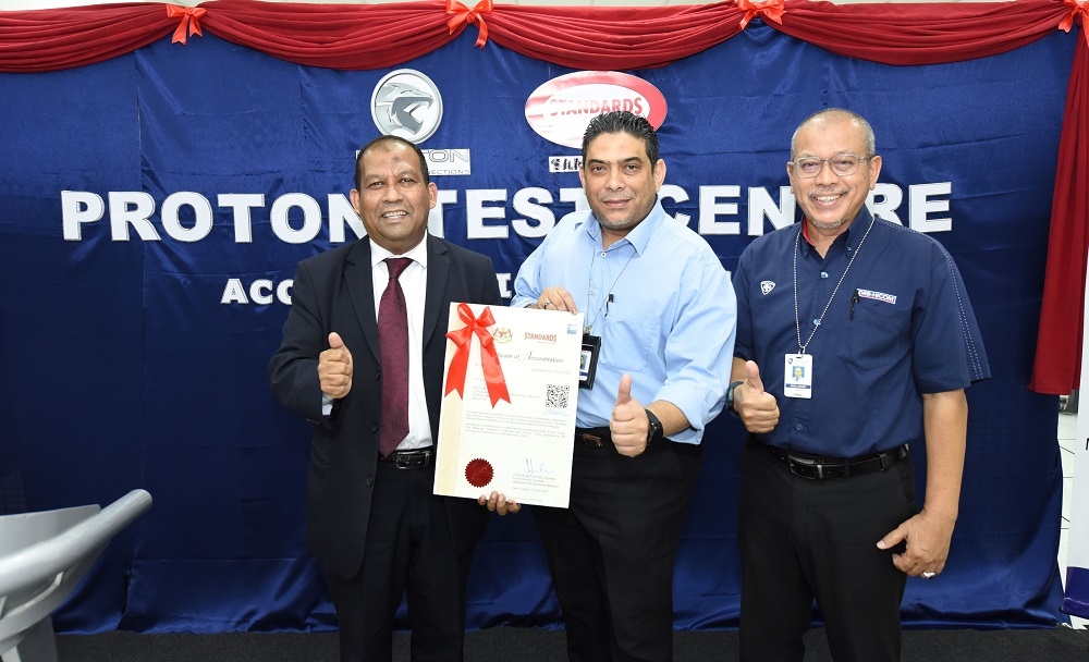 (From left) Department of Standards director-general Shaharul Sadri Alwi, Proton Group Engineering director Hazrin Fazail Haroon and Proton Engineering Validation head Abdul Wahab Long pose with the ISO/IEC 17025:2017 accreditation. — Picture courtesy of Proton 