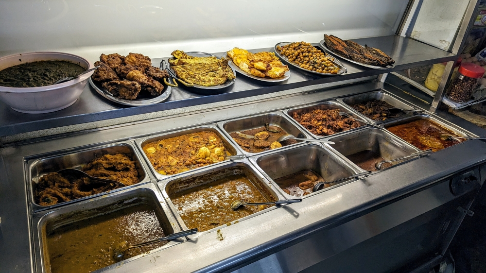 The array of curries, side dishes and fried goodies to go along with your 'roti'.