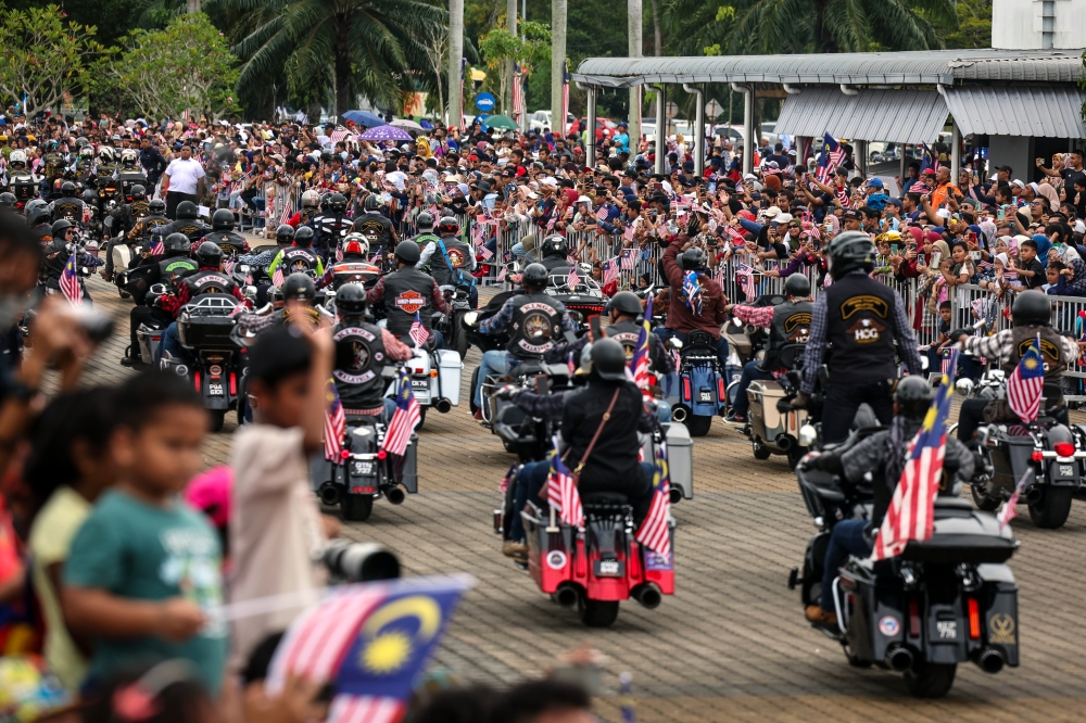 The public watch the parade and procession at the 66th National Day celebration at Batu Kawan Stadium, August 31, 2023. — Bernama pic 