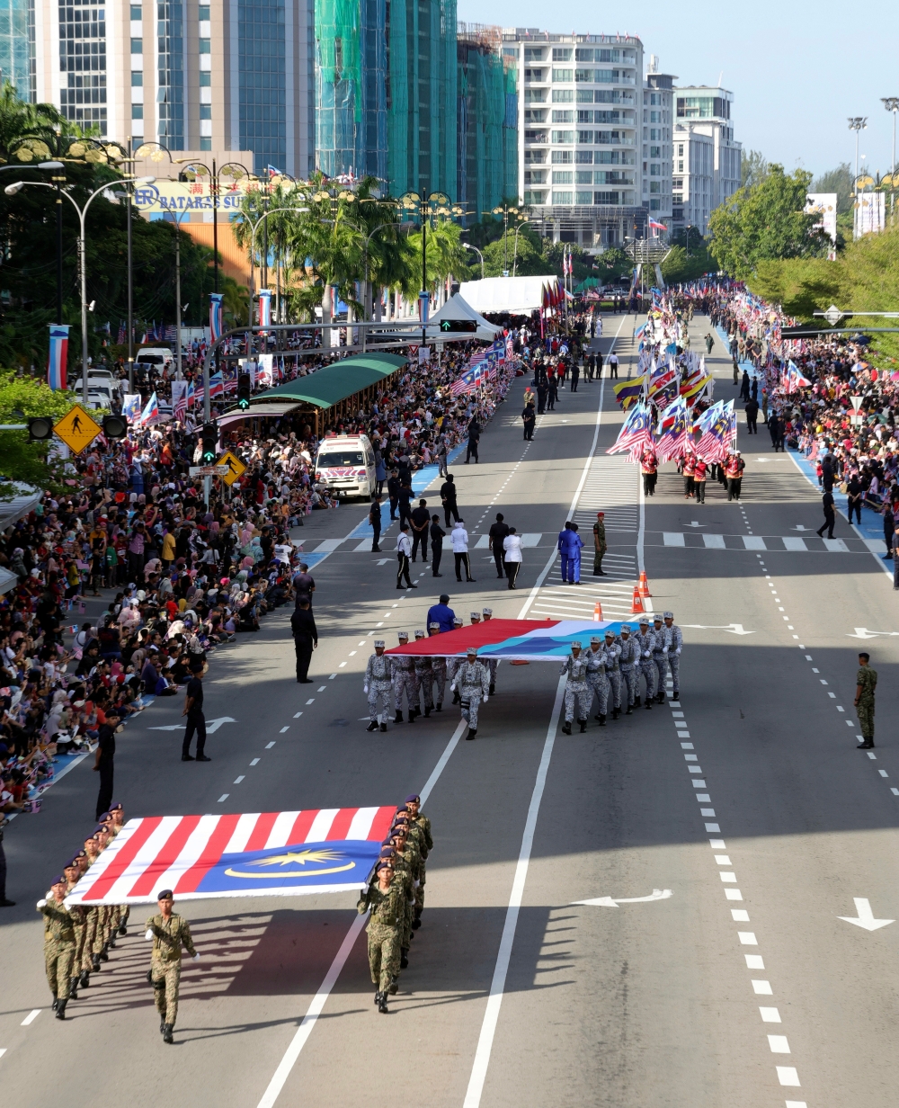 The Jalur Gemilang and the Sabah state flag were paraded during the state-level 2023 National Day celebration in Sabah, held on Jalan Tun Fuad Stephen in Kota Kinabalu, August 31, 2023. — Bernama pic 