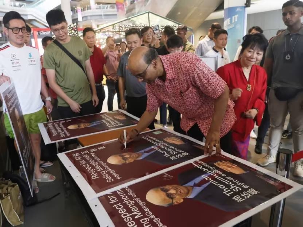 Mr Tharman Shanmugaratnam signing autographs at Our Tampines Hub on September 2, 2023. — TODAY pic