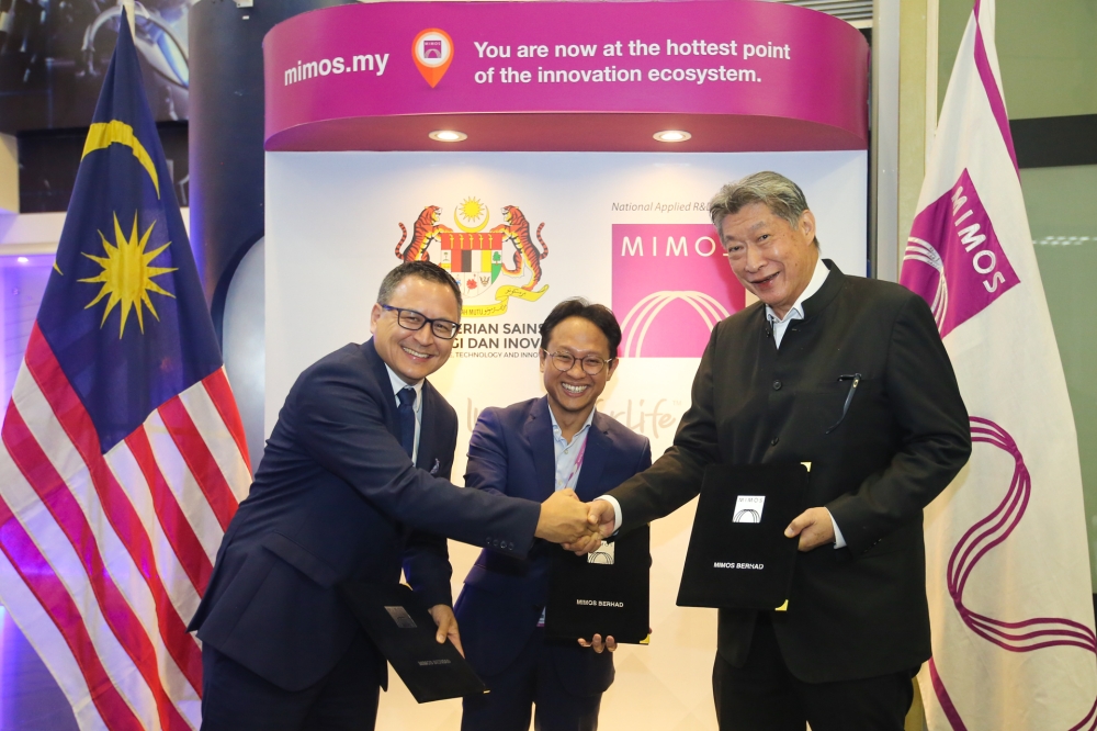 (From left) Marketing and Project Director of HELM AG Yves Florian Wolf, Mimos Berhad President and CEO Iskandar Samad and Ancom Nylex Berhad Executive Chairman Datuk Siew Ka Wei exchange documents during the Memorandum of Understanding signing ceremony at Mimos September 5, 2023. — Picture by Ahmad Zamzahuri 