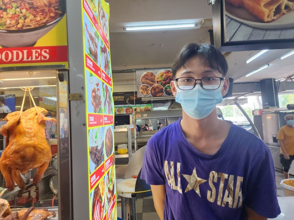 Jong Tze Long, a 21-year-old rice dish seller from Tabuan Jaya, has been selling rice dishes priced between RM6 and RM10 and has not made any price adjustments yet. ― Borneo Post pic