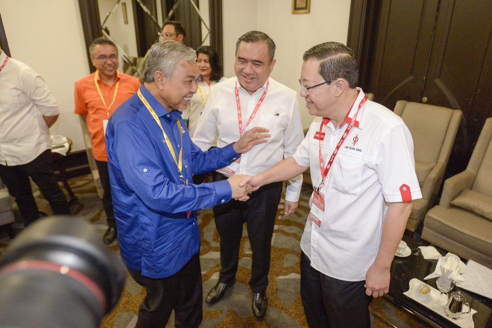 Umno president Datuk Seri Ahmad Zahid Hamidi shakes hands with DAP chairman Lim Guan Eng at the DAP National Congress at Marriot Hotel in Putrajaya September 10, 2023. — Picture by Yusof Mat Isa