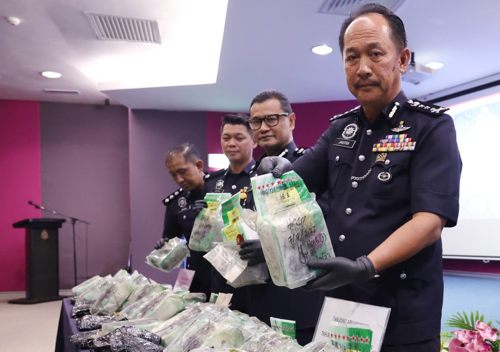 Sabah police commissioner Datuk Jauteh Dikun (right) shows drugs seized after a drug bust during a media conference at the Sabah contingent police headquarters in Kota Kinabalu September 11, 2023. — Bernama pic