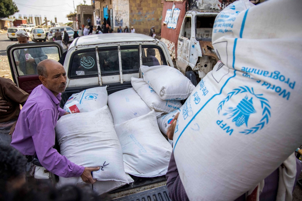 Displaced Yemenis receive humanitarian aid provided by the World Food Programme (WFP) in the city of Taiz September 11, 2023. — AFP pic