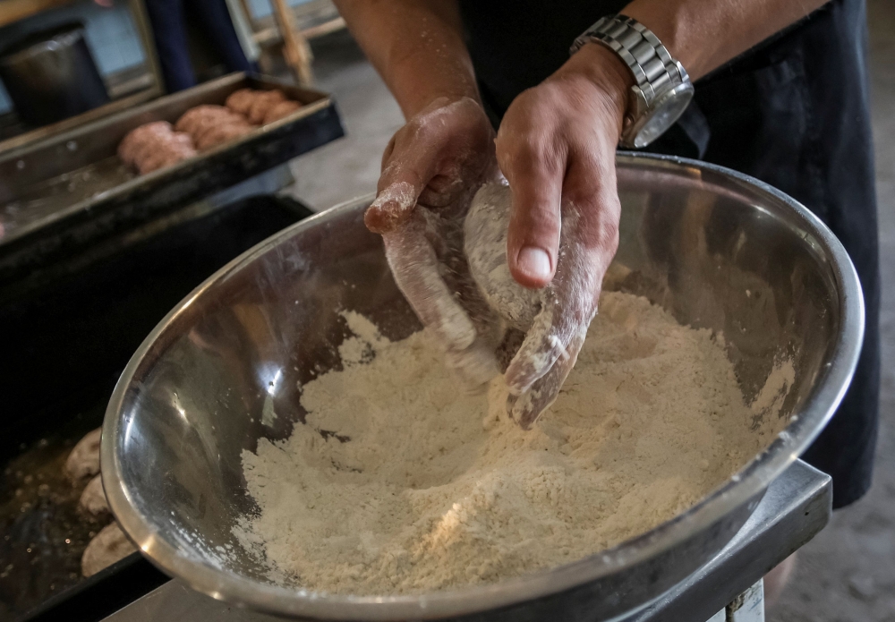 Serhiy, 30, a former restaurant chef and military cook prepares a meal, amid Russia's attack on Ukraine, in Dnipropetrovsk region September 12, 2023. — Reuters pic