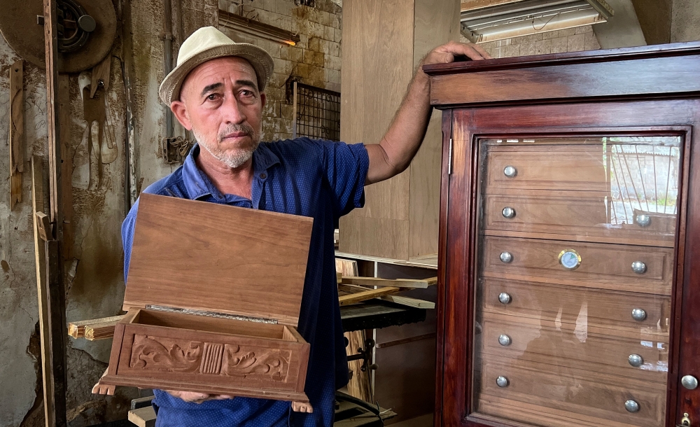 Cuban carpenter and cigar humidors maker Rene Reyes poses for a picture at his workshop in Havana, on September 5, 2023. — AFP pic