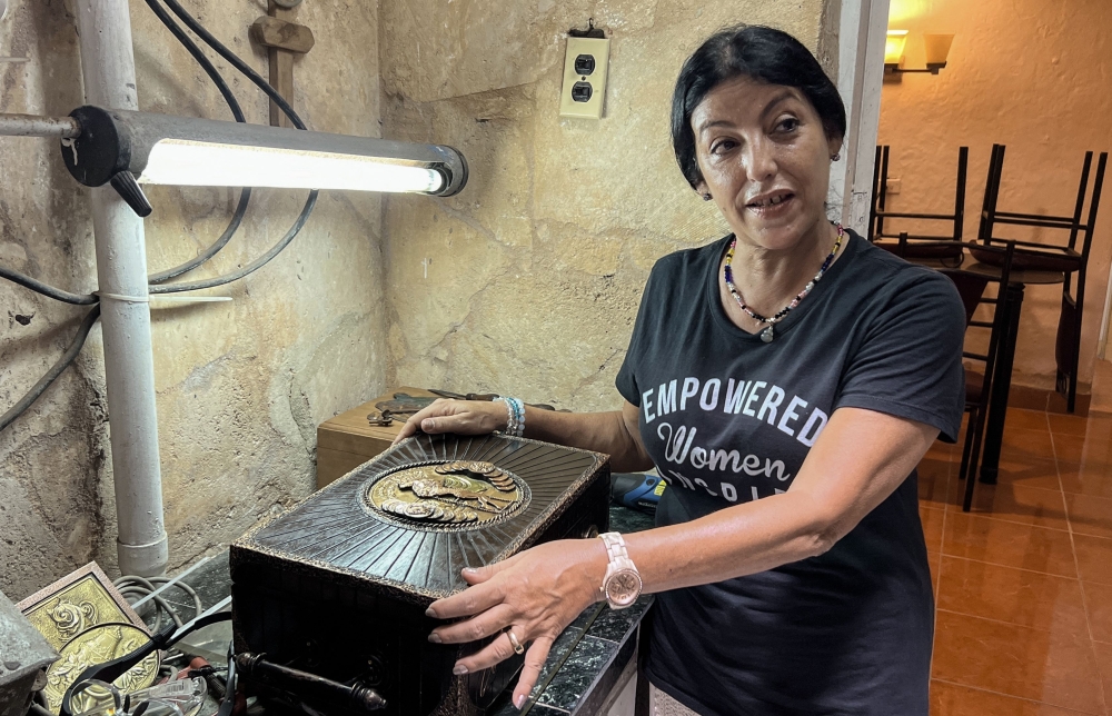 Cuban cigar humidors maker Tania Duyos, shows one of her pieces at her workshop in Havana, on September 5, 2023. — AFP pic