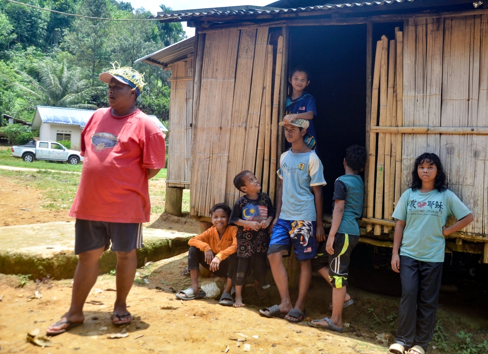 Residents of the Temiar tribe are seen outside a house in Kampung Kelaik, Pos Blau, near Gua Musang September 18, 2023. — Bernama pic