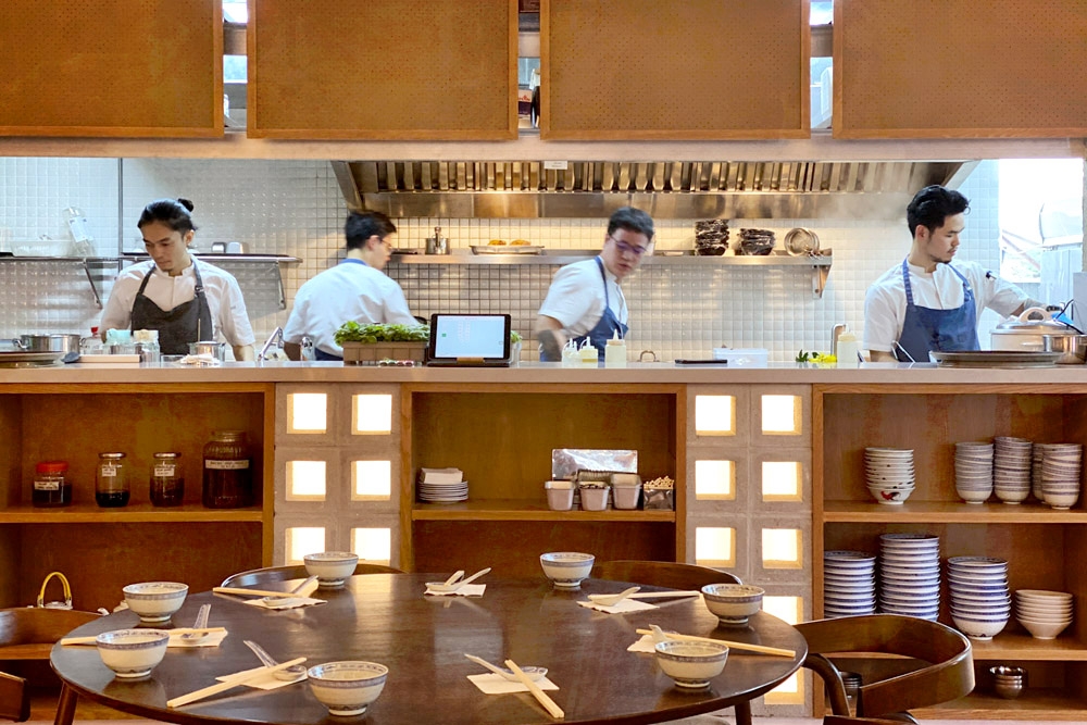 Chefs in action inside the open kitchen.