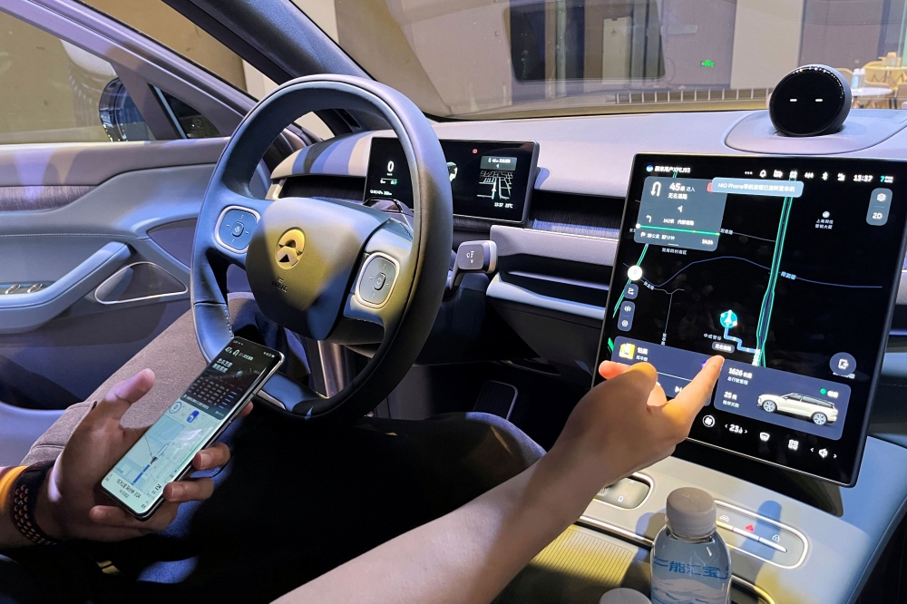 A staff member demonstrates to media members a Nio Phone's connectivity to a car during the Chinese electric vehicle (EV) maker's tech day in Shanghai, China September 21, 2023. — Reuters pic