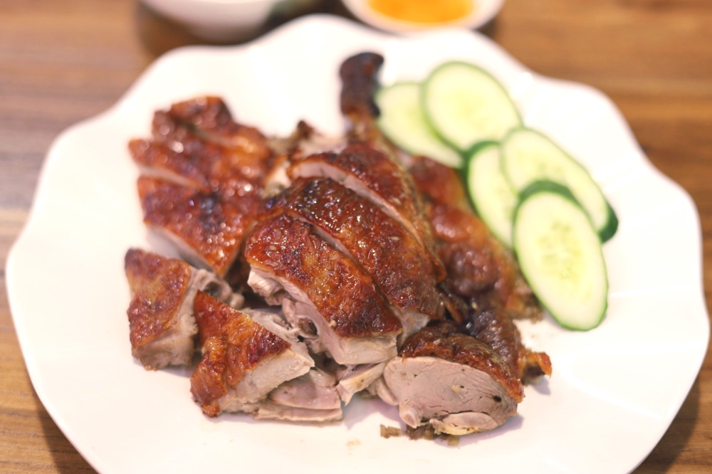 Share a quarter portion of roast duck with its tender, juicy meat.