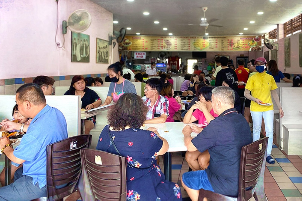 Happy Land Cafeteria is bustling with regular clientele.