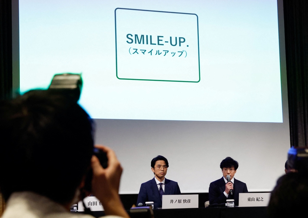 Japan’s talent agency Johnny & Associates Chief Noriyuki Higashiyama, flanked by CEO of Johnny’s Island Yoshihiko Inohara, unveils the new company name Smile-Up. during a news conference in Tokyo October 2, 2023. — Reuters pic