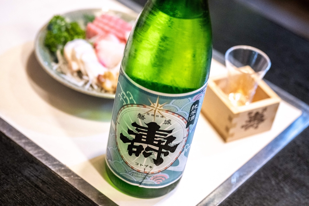 This picture taken on August 31, 2023 shows a bottle of sake from Daisuke Suzuki's brewery at a restaurant in Namie, Fukushima Prefecture. — AFP pic