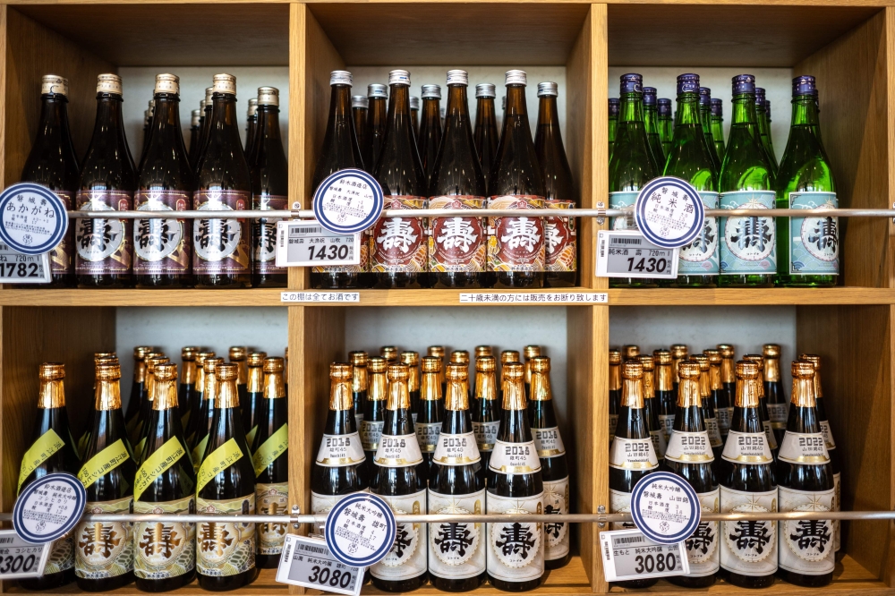 Bottles of Japanese sake at Daisuke Suzuki's brewery in Namie. — AFP pic