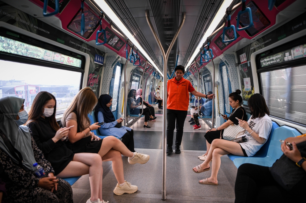 A Prasarana Malaysia Berhad volunteer and passengers on board a women-only MRT coach in Kuala Lumpur October 7, 2023. — Bernama pic