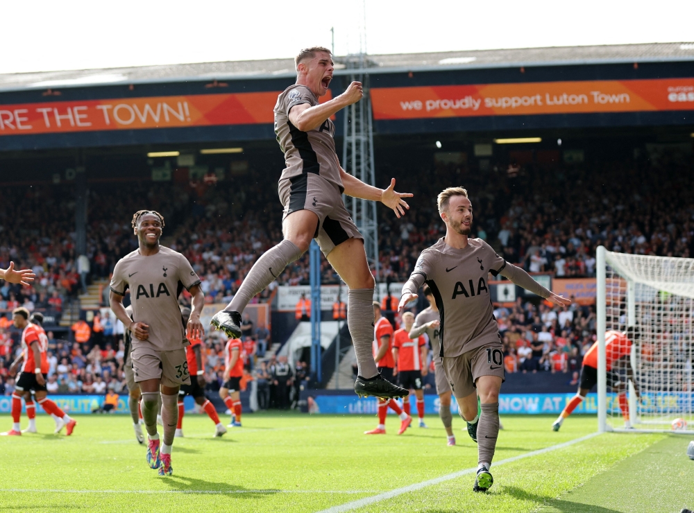 Tottenham Hotspur’s Micky van de Ven celebrates scoring their first goal with James Maddison and Destiny Udogie during their match against Luton Town at the Kenilworth Road in Luton, Britain on October 7, 2023. — Reuters pic