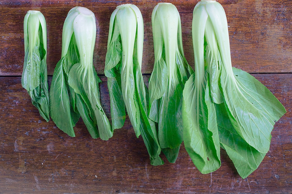 Leafy greens like 'siu bak choy' or 'nai pak' add a healthy dose of antioxidants.