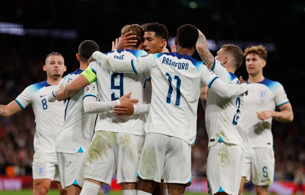 England's Harry Kane celebrates with Jude Bellingham and Marcus Rashford after scoring the first goal against Italy October 18, 2023. ― Action Images via Reuters/Andrew Couldridge