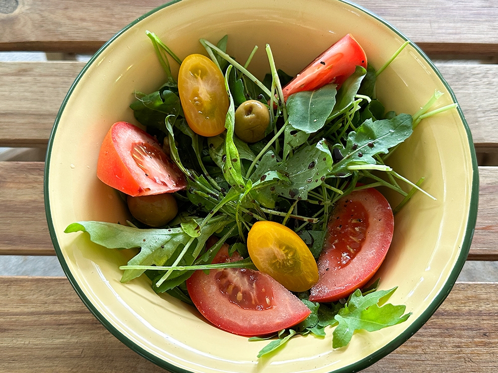 Add more greens to your meal here with this Insalata Mista with rocket, tomatoes, olives and capers.