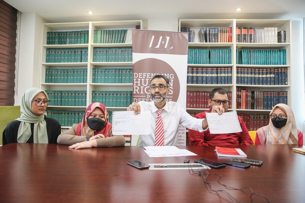 Lawyer for Liberty’s legal adviser N. Surendran (middle) speaks during a press conference on four stateless children born to a Malaysian father in Petaling Jaya, October 17, 2023. ― Picture by Yusof Mat Isa