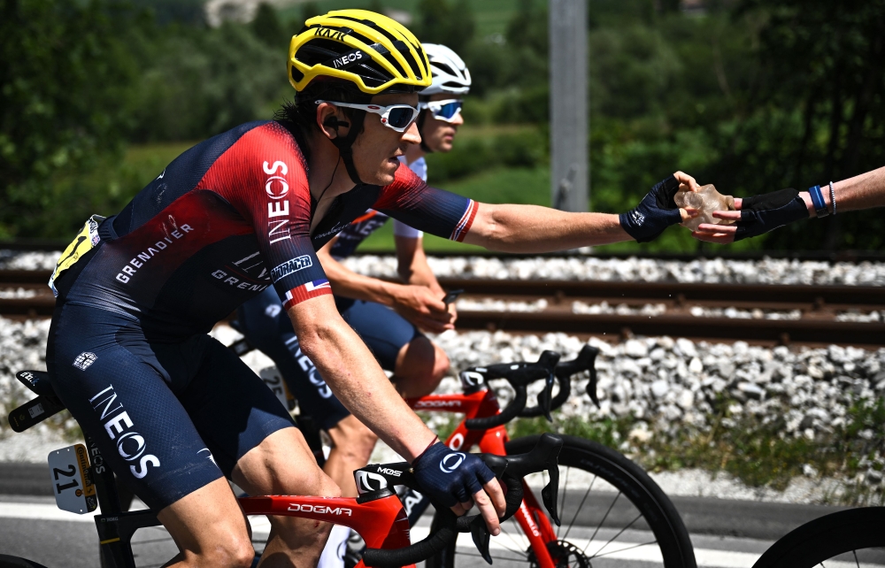 Ineos Grenadiers team's British rider Geraint Thomas is handed a block of ice as he cycles during the 9th stage of the 109th edition of the of the Tour de France cycling race, 192,9 km between Aigle in Switzerland and Chatel Les Portes du Soleil in the French Alps in this file photo taken on July 10, 2022. — AFP pic