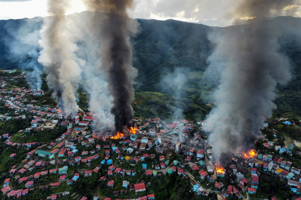 This aerial photo taken on October 29, 2021 show smoke and fires at Thantlang in Chin State, where more than 160 buildings have been destroyed by shelling from Junta military troops, according to local media. — AFP pic