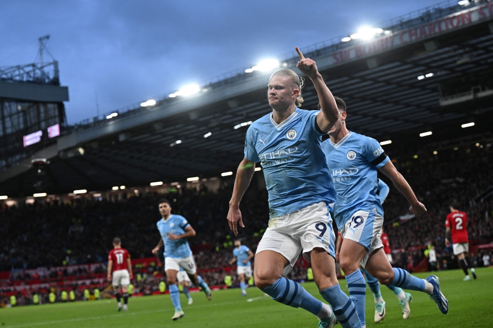 Manchester City's Norwegian striker Erling Haaland (centre) celebrates after scoring the opening goal from the penalty spot during the English Premier League football match between Manchester United and Manchester City at Old Trafford in Manchester October 29, 2023. — AFP pic