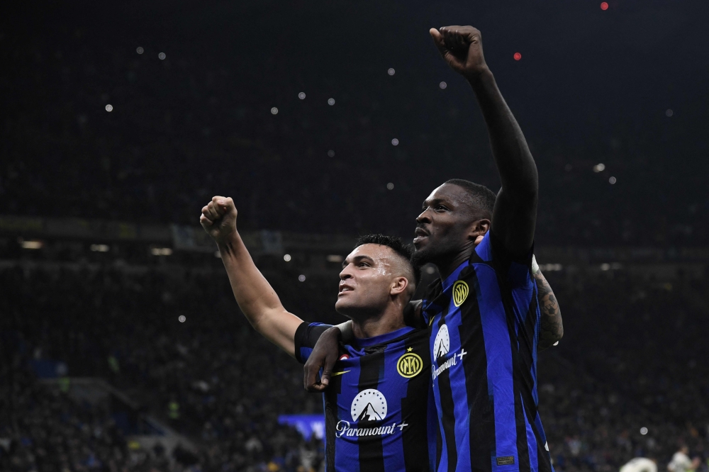 Inter Milan’s French forward Marcus Thuram (right) celebrates with teammate Inter Milan’s Argentine forward Lautaro Martinez after scoring the team’s first goal during the Italian Serie A football match between Inter Milan and AS Roma at San Siro Stadium, in Milan October 29, 2023. — AFP pic