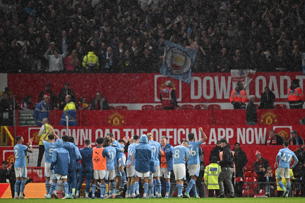 City players celebrate in front of their fans after the English Premier League football match between Manchester United and Manchester City at Old Trafford in Manchester October 29, 2023. — AFP pic